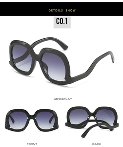Vue détaillée des lunettes de soleil oversize avec branches ondulées et verres dégradés