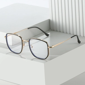 Oversized square blue light glasses with black and gold metal frames from a side view