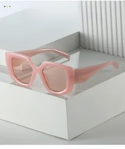 Detail of pink square sunglasses with thick frame on a modern minimalist pedestal