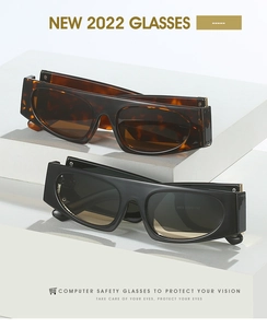 Close-up of flat top rectangle sunglasses with thick temples on a white stone base