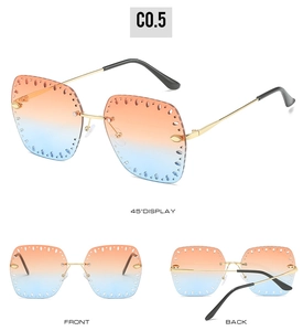 Close-up of frameless sunglasses with blue-orange gradient lenses and hollow decoration