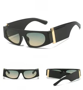 Close-up of wide gold hinges on black square frame sunglasses with blue orange gradient lens