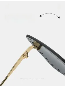 Close-up of golden metal hinge and decorative cut-outs on frameless sunglasses