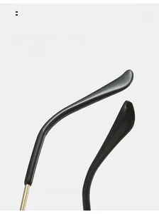 Close-up of curved black glasses legs with golden metal joints for comfortable wear