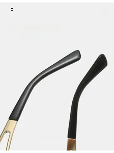 Close-up of golden hollow metal temples and curved black tips on Y2K sunglasses