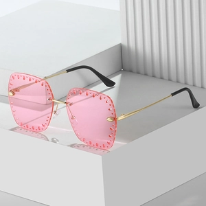 Chic pink rimless square sunglasses with gold metal frame and decorative cutout lenses
