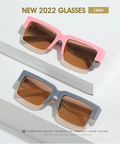Detail view of square sunglasses featuring a pink plastic and gold metal hybrid frame