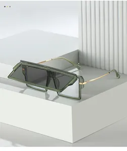Detail view of olive green geometric oversized sunglasses with gold metal temples
