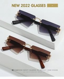Detail view of rimless sunglasses with gradient lenses and wood texture temples on stone