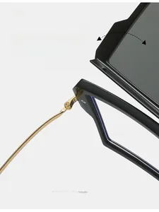 Close-up of durable golden metal texture hinge on black oversized fashion sunglasses