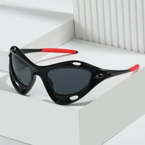 Y2K sporty cat-eye sunglasses with black frame and red rubber tips on a white block