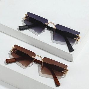 Frameless geometric sunglasses in grey and brown tints with gold metal bridge and accents