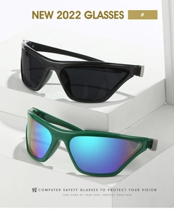 Detail of Y2K cat-eye sunglasses in black and green with metallic hinge accents