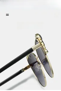Detail of gold metal frame sunglasses featuring crystal-encrusted temples and dark lenses