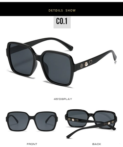 Détail de lunettes de soleil carrées noires avec décorations de rose, perle et cœur
