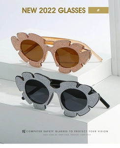 Detail of petal-shaped cat-eye sunglasses with glitter frames and tinted lenses