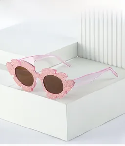 Detail of pink glitter flower-shaped kids' sunglasses with transparent temples