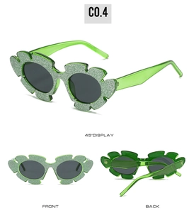 Green floral cat-eye sunglasses with glitter finish and dark grey polarized lenses