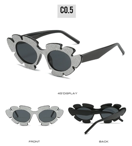 Detail of silver glitter flower frame cat eye sunglasses with dark UV lenses