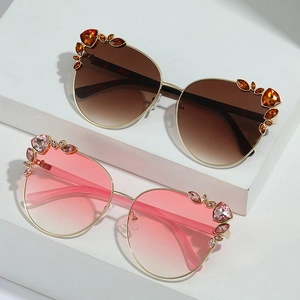 Cat eye sunglasses with rhinestones and oversized frames in amber and pink gradients