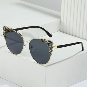 Fashionable oversized cat-eye sunglasses with rhinestone accents on a modern white background