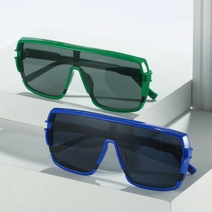 Oversized flat top shield sunglasses in vibrant green and blue on white blocks