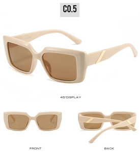 Detail view of cream rectangle sunglasses with gold metal trim and brown lenses