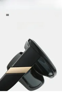 Detailed close-up of glossy black square frames with decorative gold metal temple accents