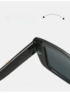 Close-up of durable metal hinges and gold accents on stylish black square sunglasses
