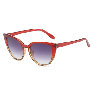 Cat eye sunglasses featuring red to tawny gradient frames and purple gradient lenses