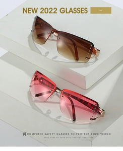 Close-up of vintage rimless sunglasses with rhinestone accents and gold metal temples