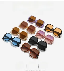 Multiple stylish oversized hexagonal sunglasses in various colors on white background