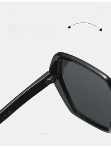 Close-up of durable metal hinges on oversized black geometric sunglasses with CE markings