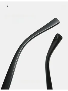 Close-up of sleek black polished curved mirror legs of geometric sunglasses