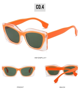 Detail view of bold cat eye sunglasses with layered orange and transparent frames