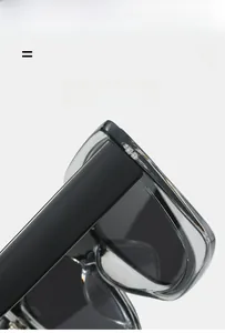 Detail of sleek black and translucent gray cat-eye sunglasses with elastic hinges