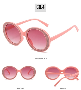 Detail of round pink sunglasses with gradient lenses and glitter rhinestone frame decorations