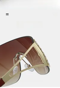 Macro detail of Y2K rimless sunglasses with gold metal frame and rhinestone accents
