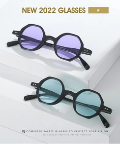 Detail of geometric polygonal sunglasses with purple and blue lenses on white blocks