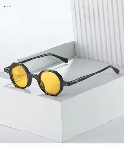 Detail of vintage polygonal sunglasses featuring black frames with vibrant yellow lenses