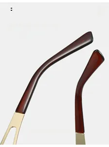Detailed macro view of curved tortoiseshell and gold metal temple for Y2K sunglasses