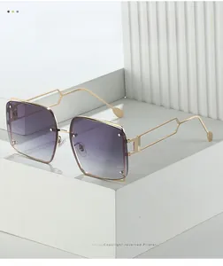 Close-up of gold metal square oversized sunglasses with gradient lenses and hollow arms