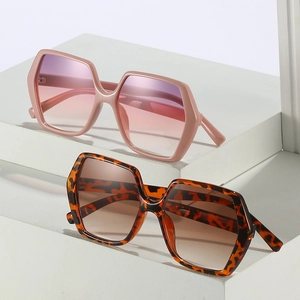 Fashionable oversized hexagonal sunglasses with pink and tortoiseshell frames and gradient lenses