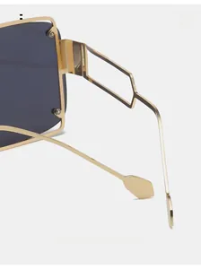 Close-up of golden metal sunglasses temples featuring ergonomic arc for comfortable wear