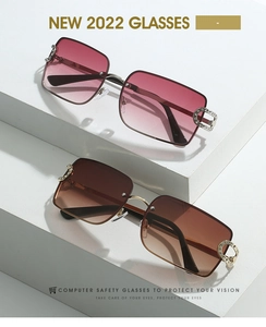 Detail of square rimless Y2K sunglasses featuring crystal horseshoe metal hinges