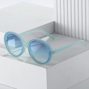 Retro round glitter sunglasses with blue gradient lenses and sparkling frame accents