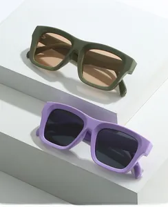 Detail view of stylish rectangle sunglasses with olive green and purple thick frames