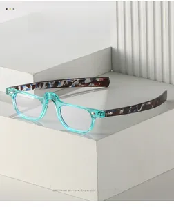 Detail of light blue transparent PC glasses frame with tortoiseshell temples on white pedestal
