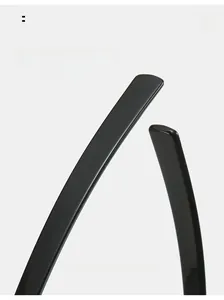 Detail shot of curved glossy black PC eyeglass temples for comfortable wear