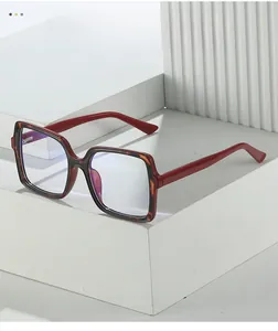 Detail of trendy square big frame glasses with red and tortoise shell contrast colors